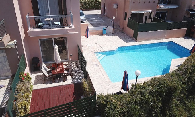 Peyia Town Casa | Direct access to the pool from the garden. A sandy beach is a few minutes away.