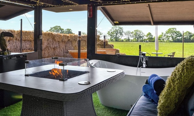 Storwood Cabaña | We just love the outside entertainment area with a bath for two, table top fire pit and large Smart