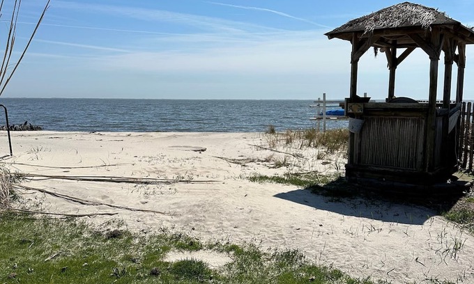 Patchogue Cabaña | A charming yellow cottage , where you can place your feet in the sand and relax!
