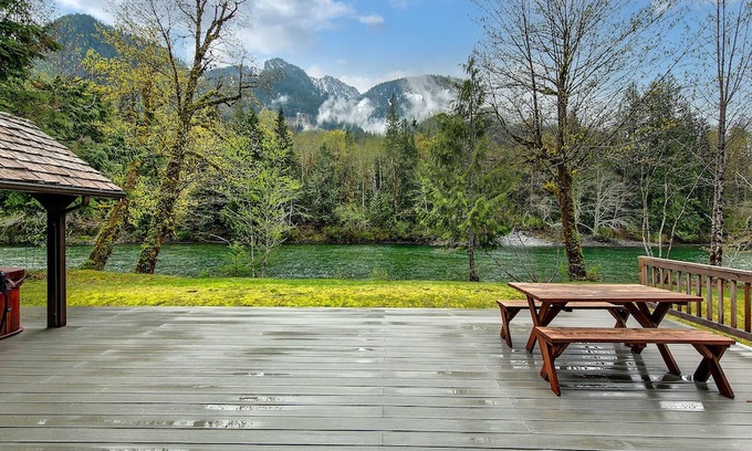 Baring Cabina | Delightful river front cabin with new hot tub and mountain views.