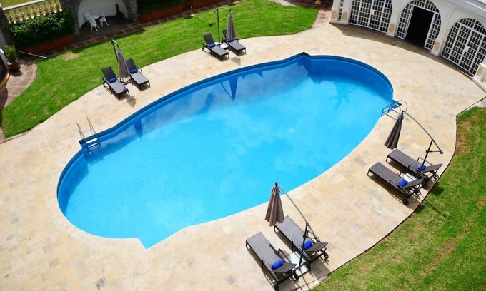Limuru Hotel | Scenic Escape: Elegant Room Overlooking Lush Grounds